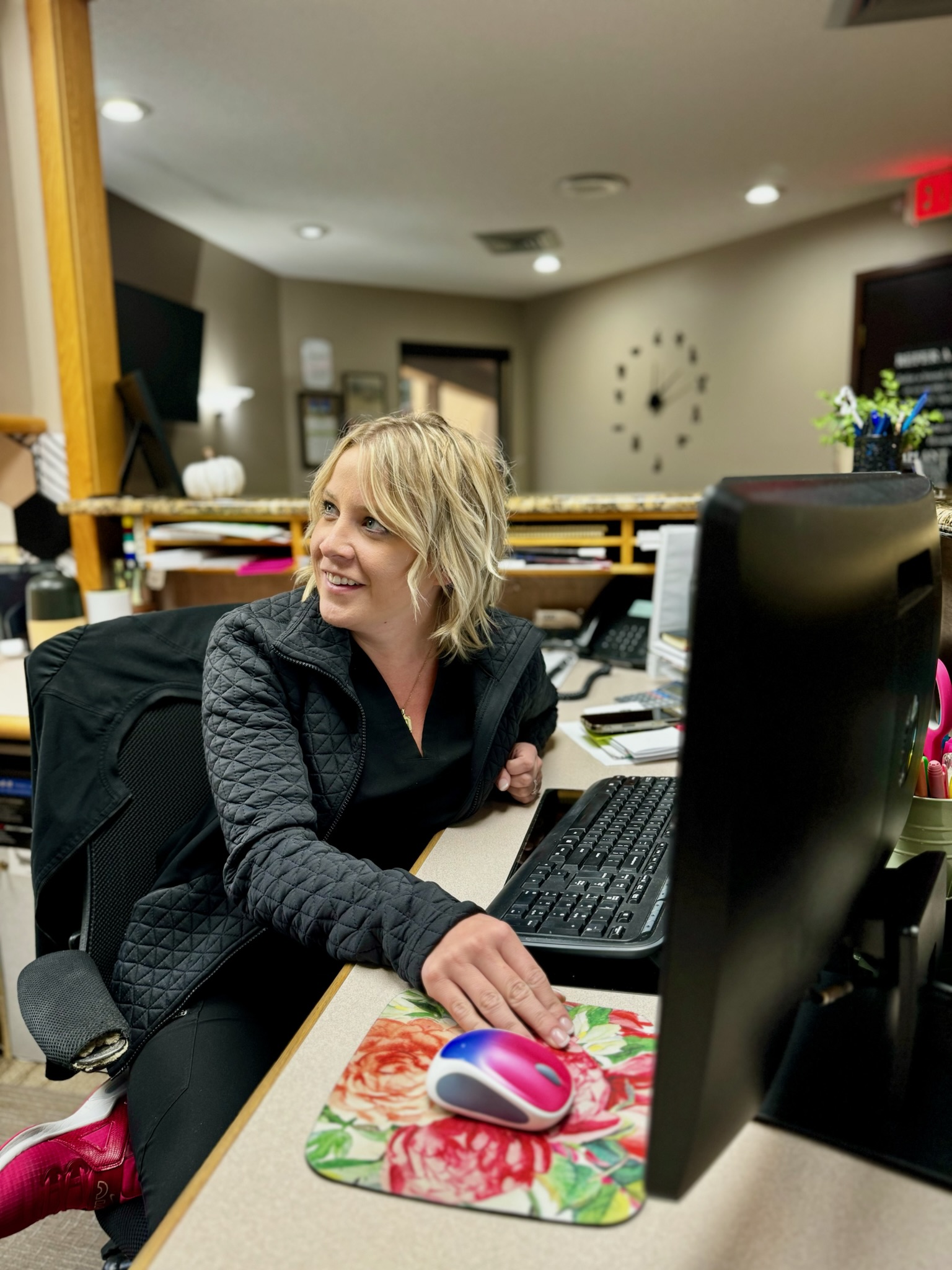 Practice Manager Aricka taking care of a patient