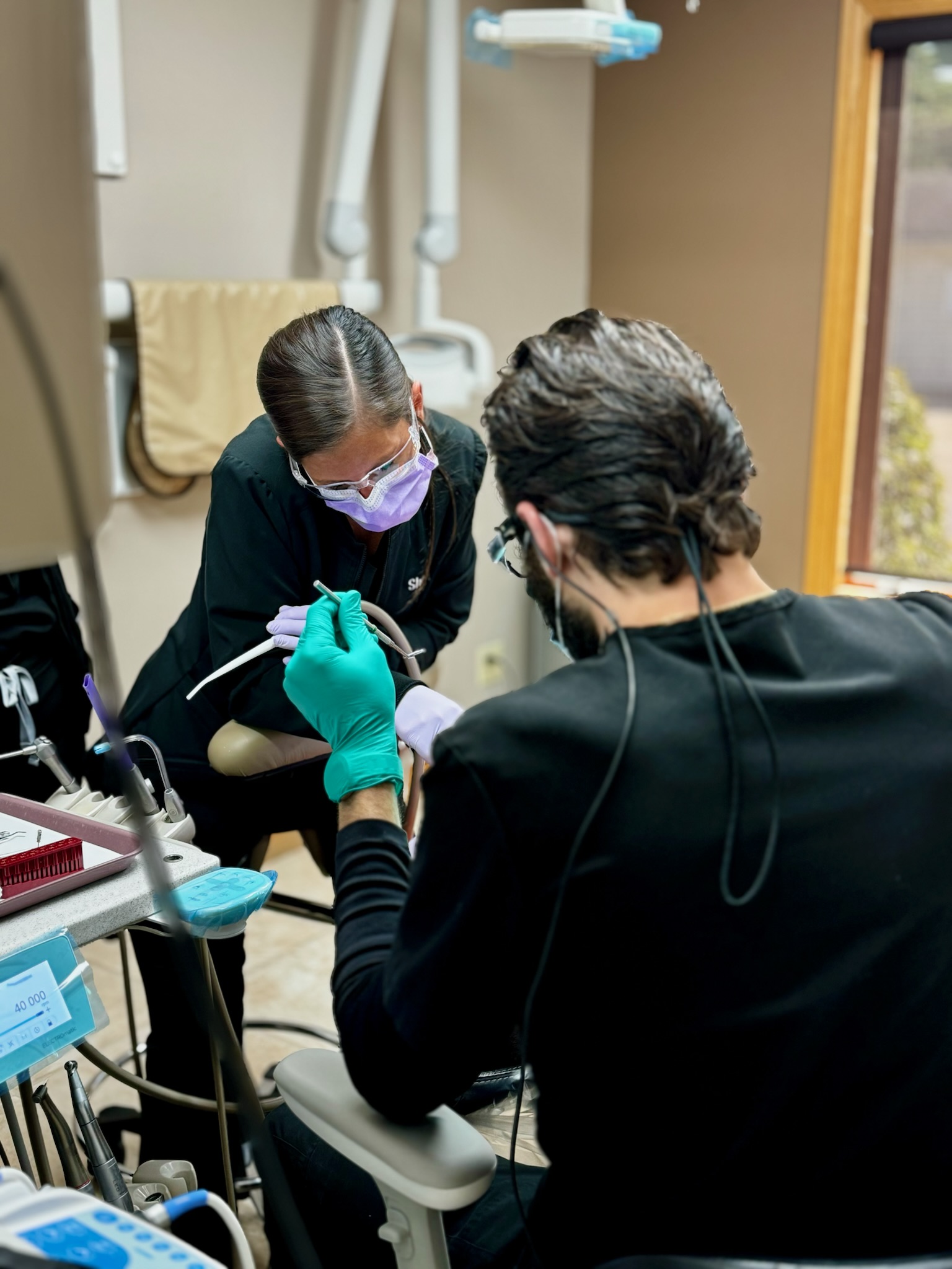 Dr. Barnard and his assistant performing dental surgery