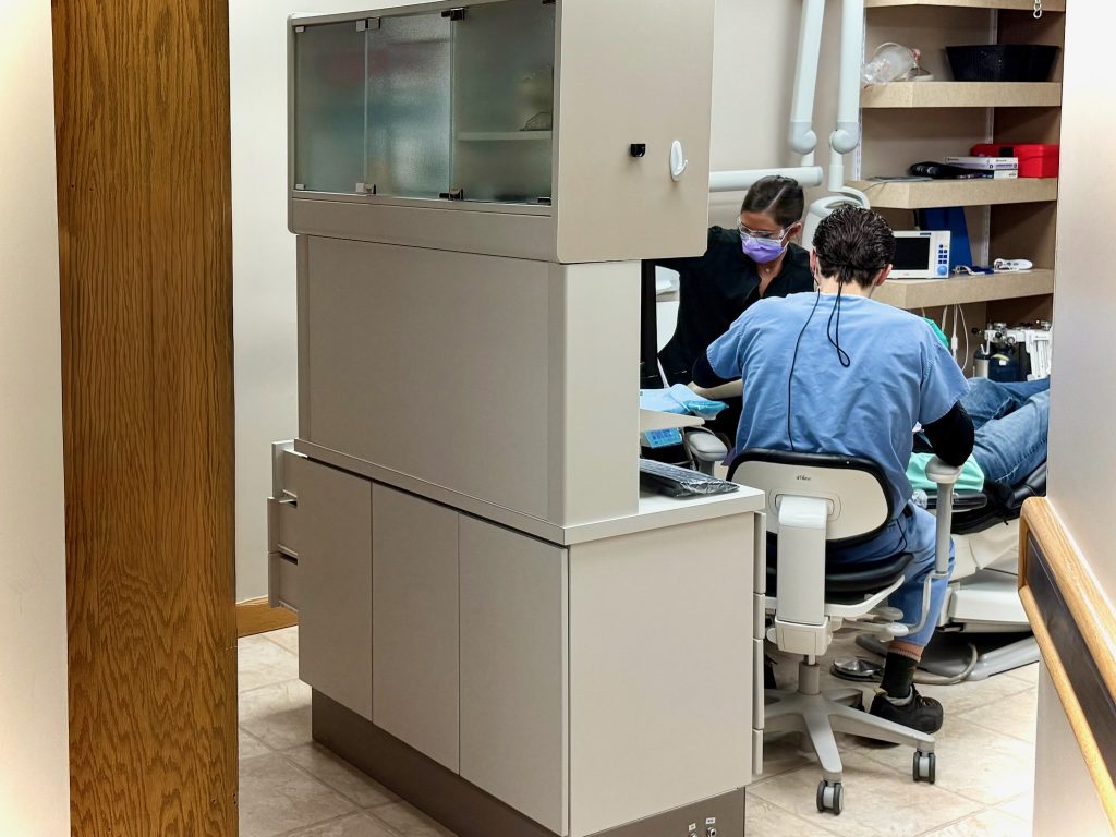 Dr. Barnard and his assistant performing dental surgery